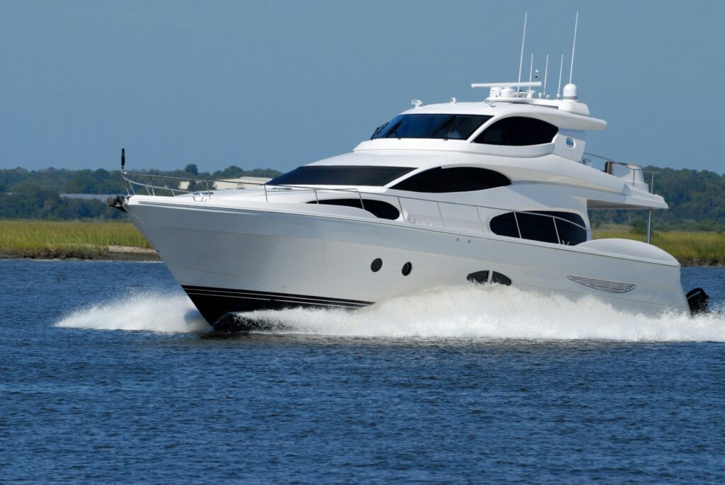 luxury-yacht-boat-speed-water-163236-163236 A modern luxury yacht cruising swiftly on a calm river under a clear blue sky.